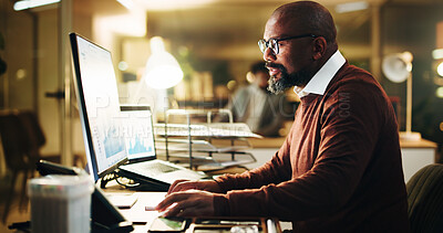 Buy stock photo Computer, finance and typing with business man in office at night for risk management. Glasses, report and review with mature male employee reading financial charts or graphs at work in evening