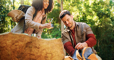 Buy stock photo Couple, hiking and help with camping stove, unpack or coffee preparation on holiday. Trekking, man and woman with portable cooking equipment in bag, travel gear and happy interracial people in woods