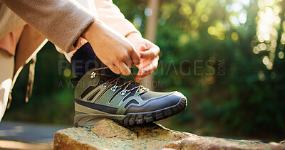 Buy stock photo Person, hands and tying shoes on rock for hiking preparation, trail or path in outdoor forest. Closeup, hiker or getting ready with tie, laces or boots for travel, trekking start or walk in nature