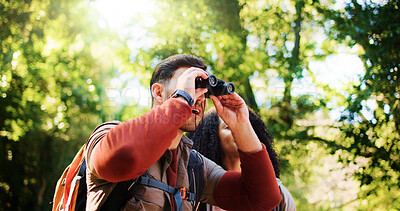 Buy stock photo Explore, hike and couple in forest with binocular, bird watching or bonding in holiday hobby. Observation, nature and tourist in woods with scope, romantic vacation or animal search in outdoor trip.