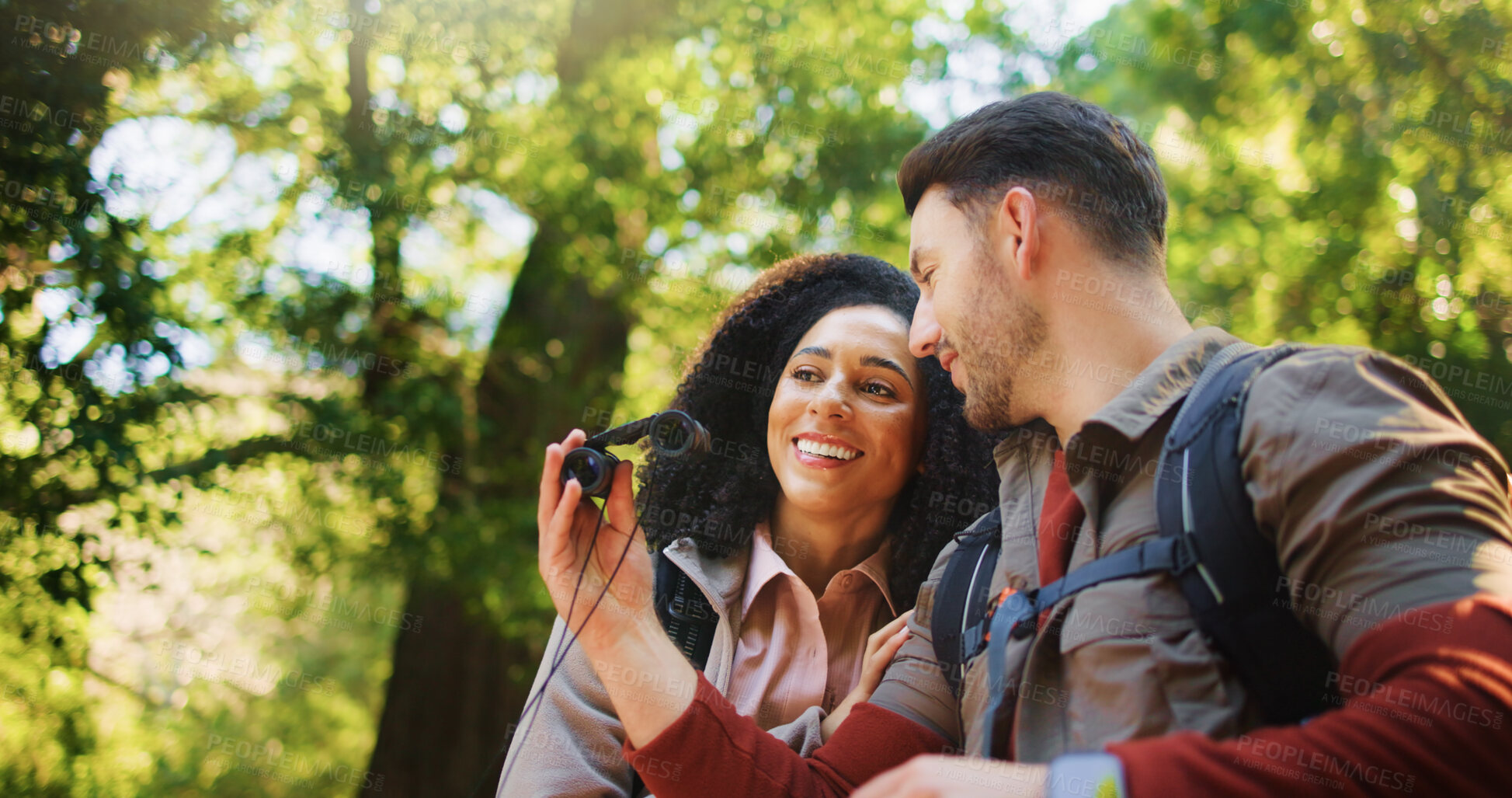 Buy stock photo Hiking, binoculars and smile with couple in nature for bird watching, trekking adventure and bonding. Backpacking date, sightseeing and travel vacation with man and woman in forest for love and hobby