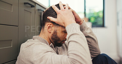Buy stock photo Depression, stress and man in kitchen with headache, mental health challenge or think of debt. Home, migraine and sad person with anxiety for financial crisis, bankruptcy reflection or regret mistake