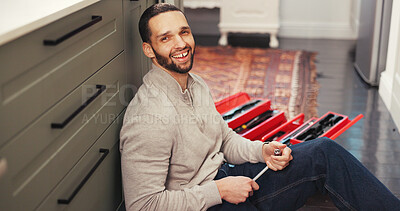 Buy stock photo Portrait, plumbing and man in home with toolbox, maintenance or testing on pipe. Smile, routine inspection and plumber in kitchen with equipment, leak detection or water system upgrade in sink repair