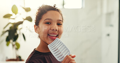 Buy stock photo Hairbrush, smile and child singing in bathroom for morning routine, performance and good mood. Happy girl, kid and karaoke with hair tool, space and playful face with portrait for music in home