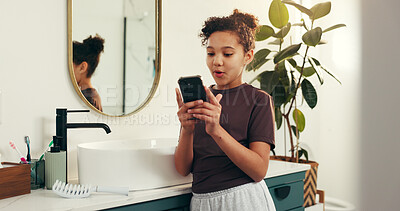 Buy stock photo Phone, smile and child in bathroom in home with social media, networking or communication. Happy, technology and girl kid with cellphone for contact or online scroll on mobile app in morning at house