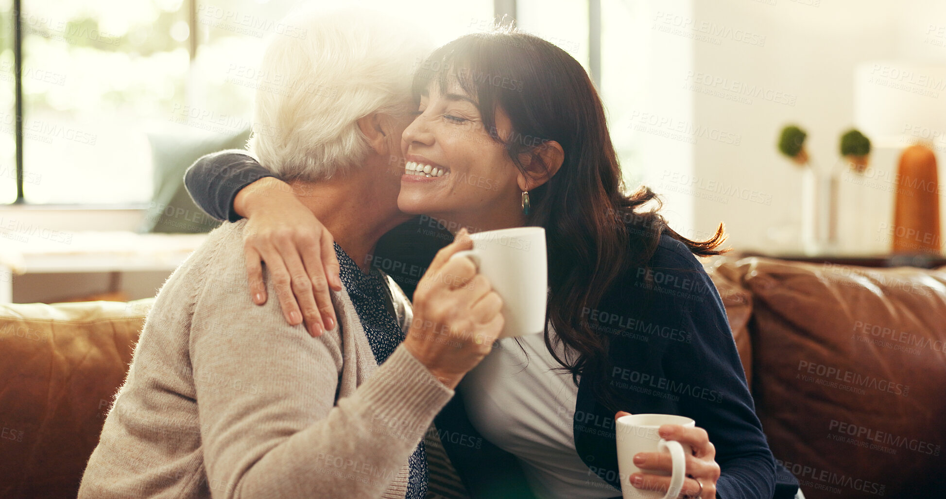 Buy stock photo Smile, coffee and hug with senior mother and daughter on sofa for love, bonding or support. Retirement, care and drinking tea with women in living room of family home for trust, connection or embrace