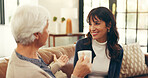 Bonding, elderly mother and daughter in home with tea, story time and catch up in conversation. Smile, communication and family in house with warm drinks, reunion and gossip in shared moment.