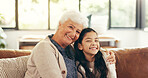 Portrait, house and grandmother with girl, hug and bonding together, smile, love and relax in lounge. Apartment, family and granny on sofa, kid and relationship with embrace, care and happiness