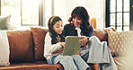 Home, tablet and mother on couch, girl and bonding together with smile, internet and help. Elearning, happy parent and family on sofa, mama and daughter with tech, talking and digital app for puzzle