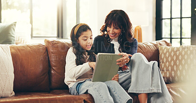 Buy stock photo Home, tablet and mother on couch, girl and bonding together with smile, internet and help. Elearning, happy parent and family on sofa, mama and daughter with tech, talking and digital app for puzzle
