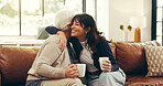 Relax, coffee and hug with senior mother and daughter on sofa for love, bonding or support. Retirement, care and drinking tea with women in living room of family home for trust, connection or embrace