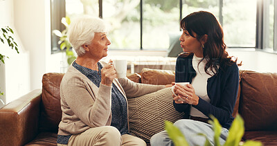 Buy stock photo Bonding, elderly mother and mature daughter in home with tea, story time and catch up in conversation. Smile, communication and family in house with warm drinks, reunion and gossip in shared moment.