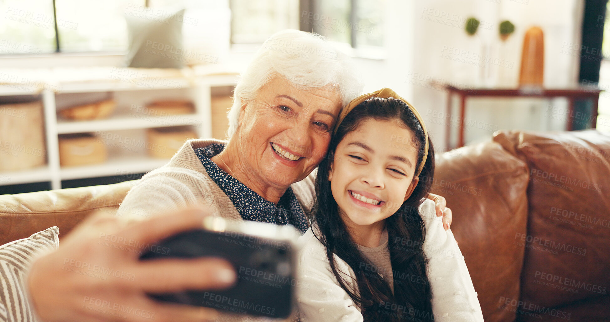 Buy stock photo Relax, selfie and grandmother with child on sofa in family home for memory, bonding and profile picture. Happiness, photography and smile with old woman and kid in living room for love, hug and care