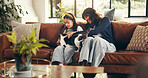 Cat, cuddle or love with mother and daughter on sofa in living room of home together for bonding. Happy, relax or smile with girl child, pet and single parent woman in apartment for weekend wellness
