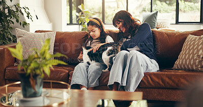 Buy stock photo Cat, cuddle or love with mother and daughter on sofa in living room of home together for bonding. Happy, relax or smile with girl child, pet and single parent woman in apartment for weekend wellness