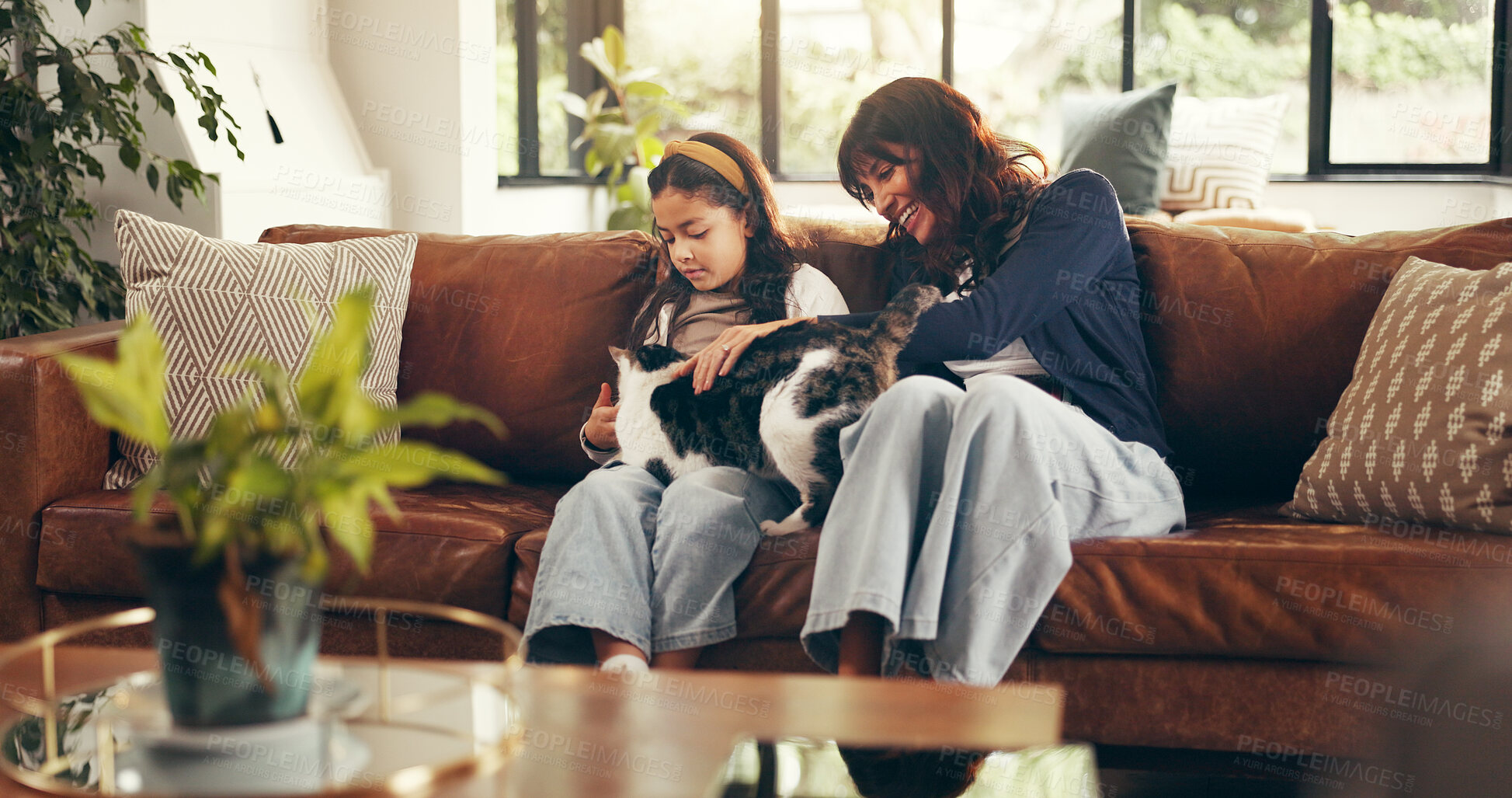 Buy stock photo Cat, cuddle or love with mother and daughter on sofa in living room of home together for bonding. Happy, relax or smile with girl child, pet and single parent woman in apartment for weekend wellness