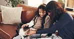 Cat, love or stroke with mother and daughter on sofa in living room of home together for bonding. Cuddle, relax or smile with girl child, pet and single parent woman in apartment for weekend wellness