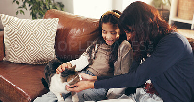 Buy stock photo Cat, love or stroke with mother and daughter on sofa in living room of home together for bonding. Cuddle, relax or smile with girl child, pet and single parent woman in apartment for weekend wellness