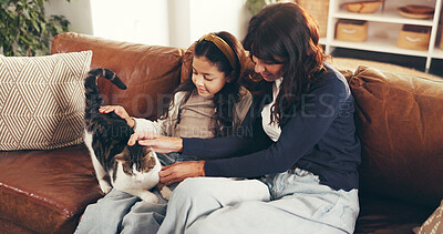 Buy stock photo Cat, cuddle or relax with mother and daughter on sofa in living room of home together for bonding. Break, love or smile with girl child, pet and single parent woman in apartment for weekend wellness