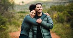 Fitness, couple and hug on adventure, forest or bonding with smile, love and hike in nature or trip. Outdoor, man and embrace with woman on weekend, care or together on holiday, healthy and wellness