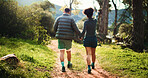 Couple, back and holding hands with nature for hiking journey, sightseeing or outdoor exploration. Man, woman or trekking together with path or trail for walk, fitness or exercise in forest or woods