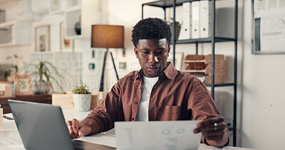 Buy stock photo Paperwork, laptop or black man reading in office for review, platform engagement and charts or graphs. Computer, infographic or document with social media agent in workplace for traffic statistics