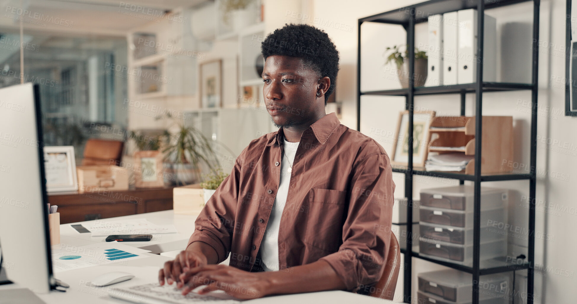 Buy stock photo Computer, typing and black man in office for review, platform engagement and charts or graphs. Document, networking and paperwork with social media agent planning in workplace for traffic statistics