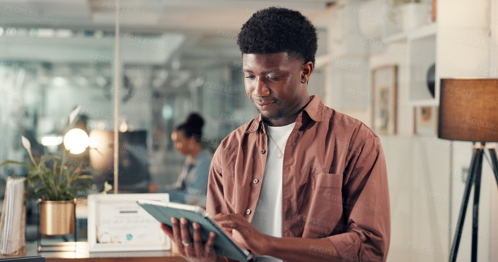 Buy stock photo Business man, reading or research with tablet in office, info or analysis for marketing campaign. Night, review or employee with tech to check online traffic or multimedia project at creative startup