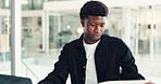 Reading, document and black man in office with laptop, data collection and review on company metric. Editing, operation and market analyst in workplace with tech, strategy or feedback report for KPI.