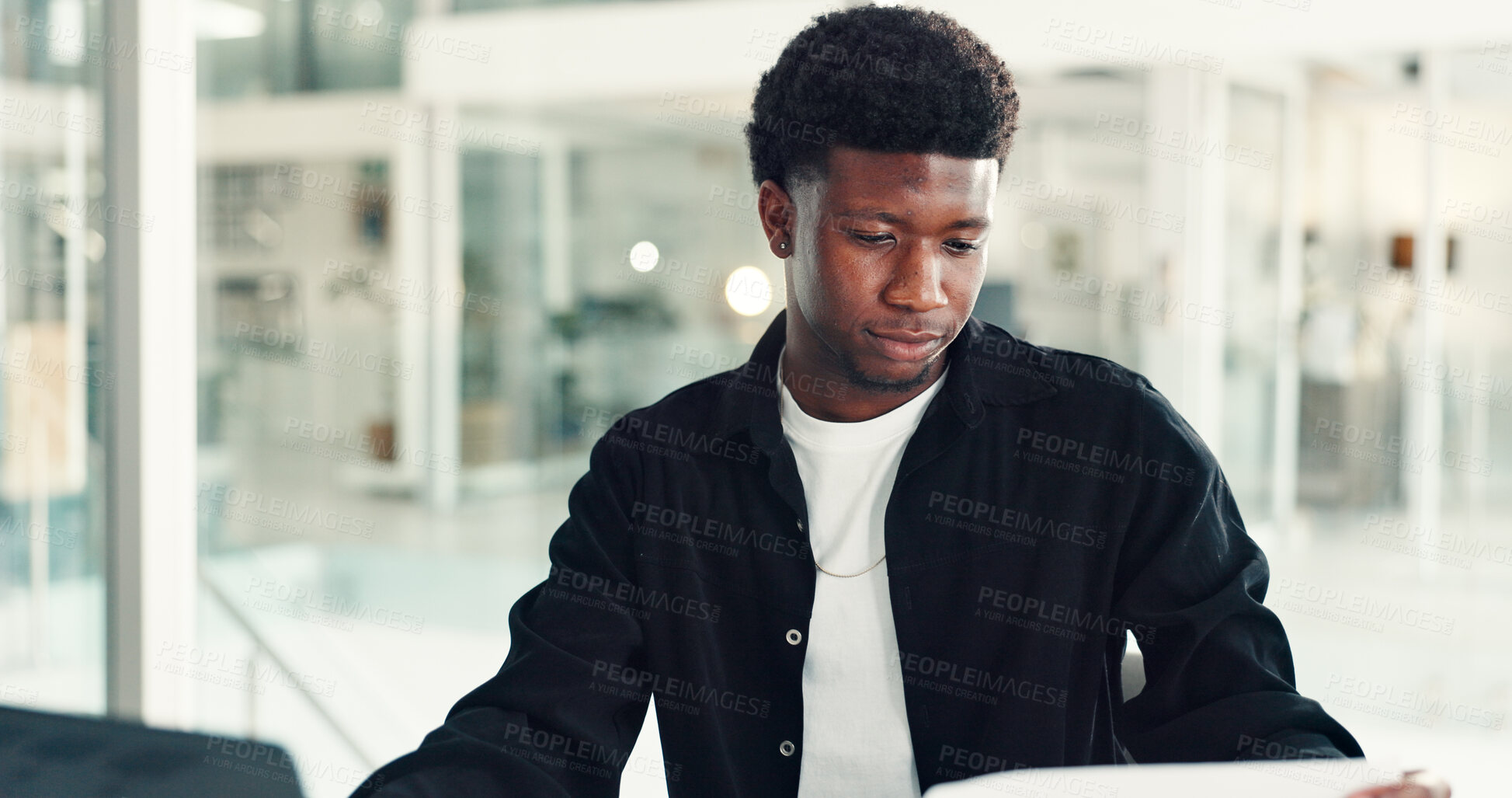 Buy stock photo Reading, paper and black man in office with laptop, review or presentation prep on company performance. Editing, operation and market analyst in agency with tech, strategy or feedback report for KPI.