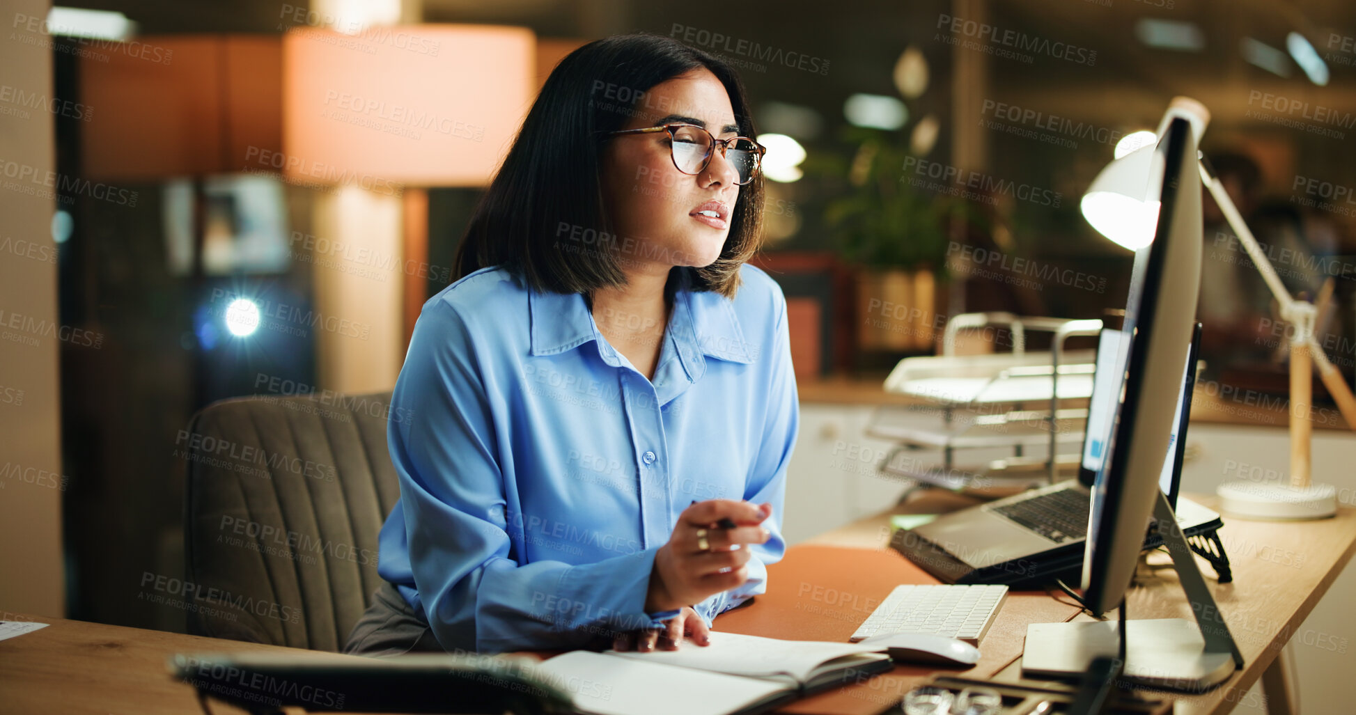 Buy stock photo Research, woman and computer with notebook at night for editing process, article notes or deadline. Reading, editor and tech at publishing agency for news headline, submission feedback and overtime