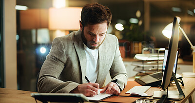 Buy stock photo Writing, night and man in office with desktop, idea or word development for screenplay. Concentration, creative and screenwriter at agency with notebook, editor feedback and revision on late shift.