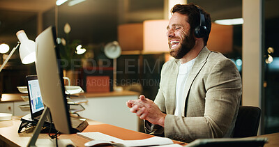 Buy stock photo Night, laugh or businessman in office with headphones, comedy podcast or funny video for work break. Overtime, happy or investor with computer in workplace, streaming or watching online for rest
