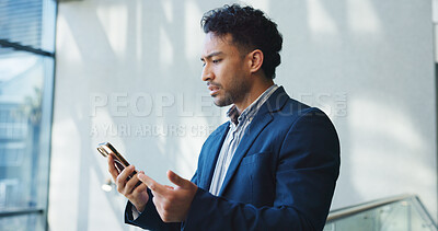 Buy stock photo Phone, upset and businessman in office with networking, communication and contact on mobile app. Research, technology and corporate employee with cellphone for email, chatting or texting in workplace