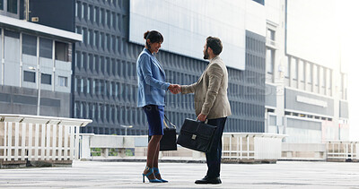 Buy stock photo Business people, meeting and city with handshake for partnership, b2b or introduction. Businessman, woman or colleagues shaking hands with deal for teamwork, collaboration or agreement in urban town