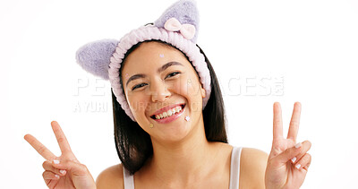 Buy stock photo Peace sign, portrait and skincare with woman in studio for aesthetic cosmetics or dermatology. Acne patches, cat ears headband and emoji with smile of happy model on white background for beauty