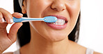 Woman, mouth and brushing teeth with toothbrush in studio for dental hygiene on a white background. Closeup, female person or model cleaning tooth for healthy gums, fresh breath or oral healthcare