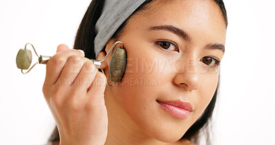 Buy stock photo Woman, face and skincare with jade roller for massage or anti aging on a white studio background. Female person, model or hand with beauty tool for facial treatment, lymphatic drainage or circulation