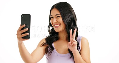 Buy stock photo Woman, selfie and peace sign in studio for hair care, salon review or social media platform. Girl, smile or photography on white background with hairstyle, beauty blog update or hand V with happiness