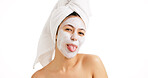 Facial, portrait and skincare with woman in studio for beauty treatment, tongue out and clay mask. Detox cosmetics, spa glow and dermatology with female person on white background for self care