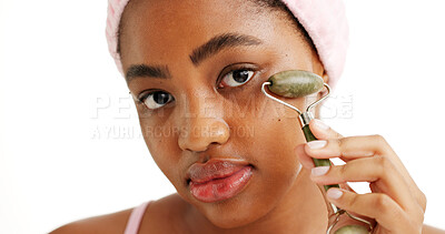 Buy stock photo Black woman, jade roller and beauty in studio portrait, tools and circulation on white background. African girl, wellness and facial massage for skincare, dermatology or lymphatic drainage in Nigeria