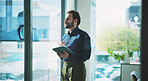 Business man, window and thinking in office with tablet, idea or plan for online campaign. Serious, person and digital marketing manager in company with tech, reflection and research for ROI.
