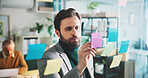 Business man, writing and sticky note on glass for planning, brainstorming or project agenda at finance firm. Ideas, strategy and male person with schedule, tasks and financial research on board