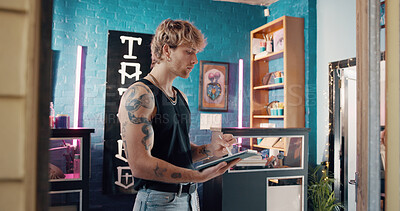 Buy stock photo Pen, small business and tablet with man in tattoo parlor for artistic design or creative planning. App, drawing and illustration with person in studio for ink or process of body art development