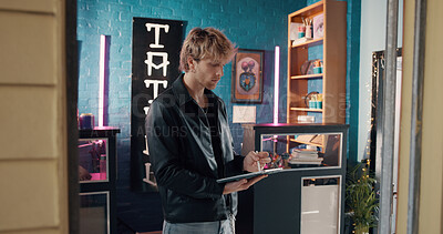 Buy stock photo Drawing, small business and tablet with man in tattoo parlor for artistic design or creative planning. App, idea and pen with designer person in studio for ink or process of body art development