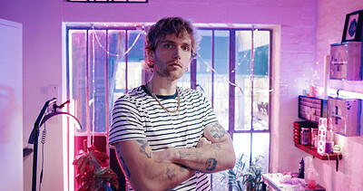 Buy stock photo Portrait, neon and man in tattoo studio with arms crossed, design and startup owner of parlor. Creative, professional and artist in store with confidence, about us and ink culture in small business.