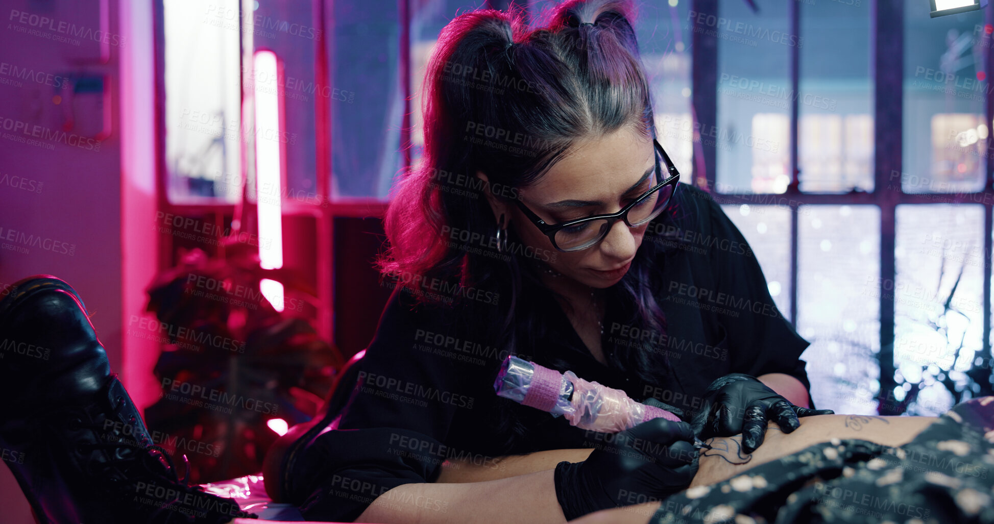 Buy stock photo Tattoo, artist and leg with woman in store for permanent ink, linework design or aesthetic. Culture, self expression and tattooing parlor with person and customer in studio for identity and body art