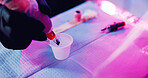 Hands, tattoo artist and machine in ink cup for hygiene, sterilization and preparation in studio. Person, body art and equipment for pigment, color and neon light for creative design in parlor