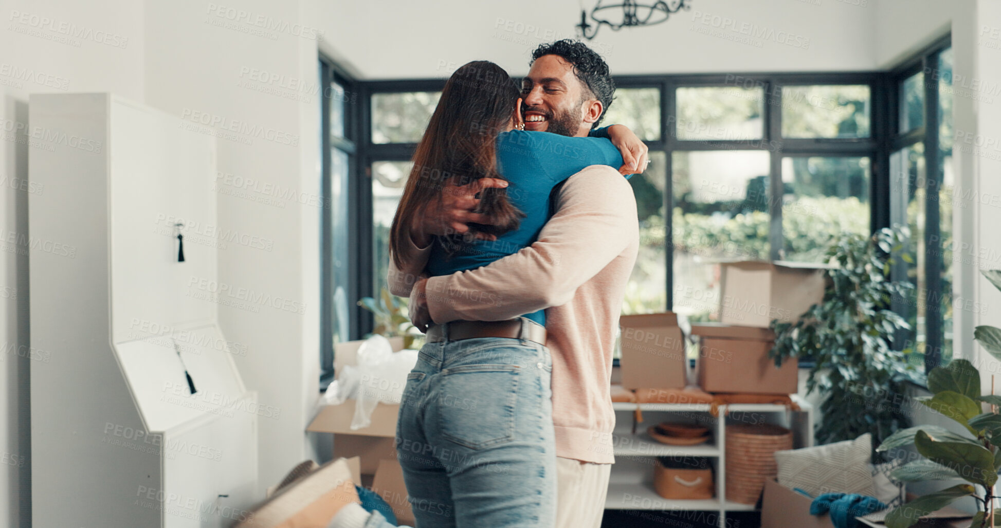 Buy stock photo Happy couple, hug and relocation at new home with boxes, excited and fresh start with property investment. People, man and woman with embrace, care and love with moving, celebration and real estate