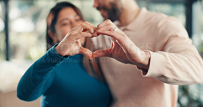 Buy stock photo Couple, heart hands and sign at new home, moving and property sale with relocation for fresh start. People, partnership and symbol with love, celebration and support for achievement at apartment